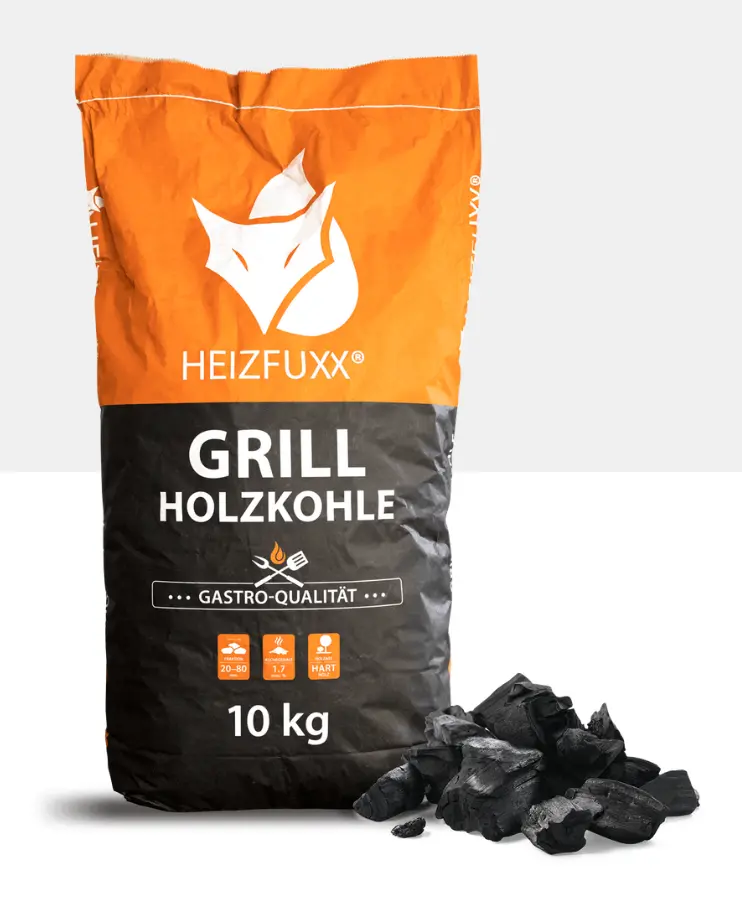 Ein großer Sack Grillholzkohle von HEIZFUXX mit einem Haufen Grillkohle im Vordergrund